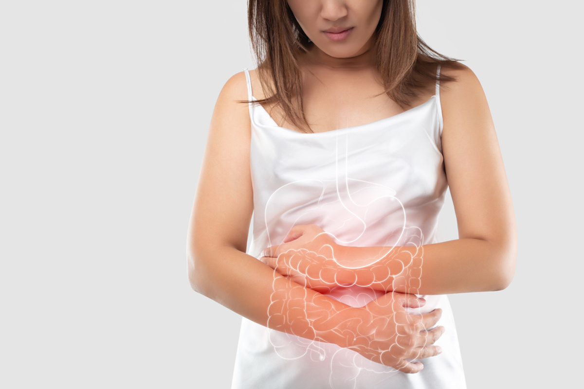 Illustration of the bowel and internal organs in the female body against a gray background and space left. The concept of medical treatment and health care. Woman is possibly suffering from constipation