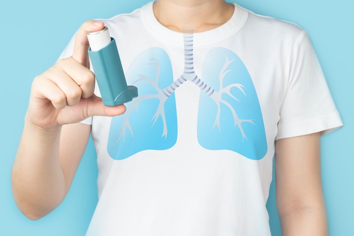 Young Woman Using Blue Asthma Inhaler for Relief Asthma Attack Pharmaceutical Products is Used to Prevent and Treat Wheezing and Shortness of Breath Caused Asthma or Copd Lung Organ Anatomy