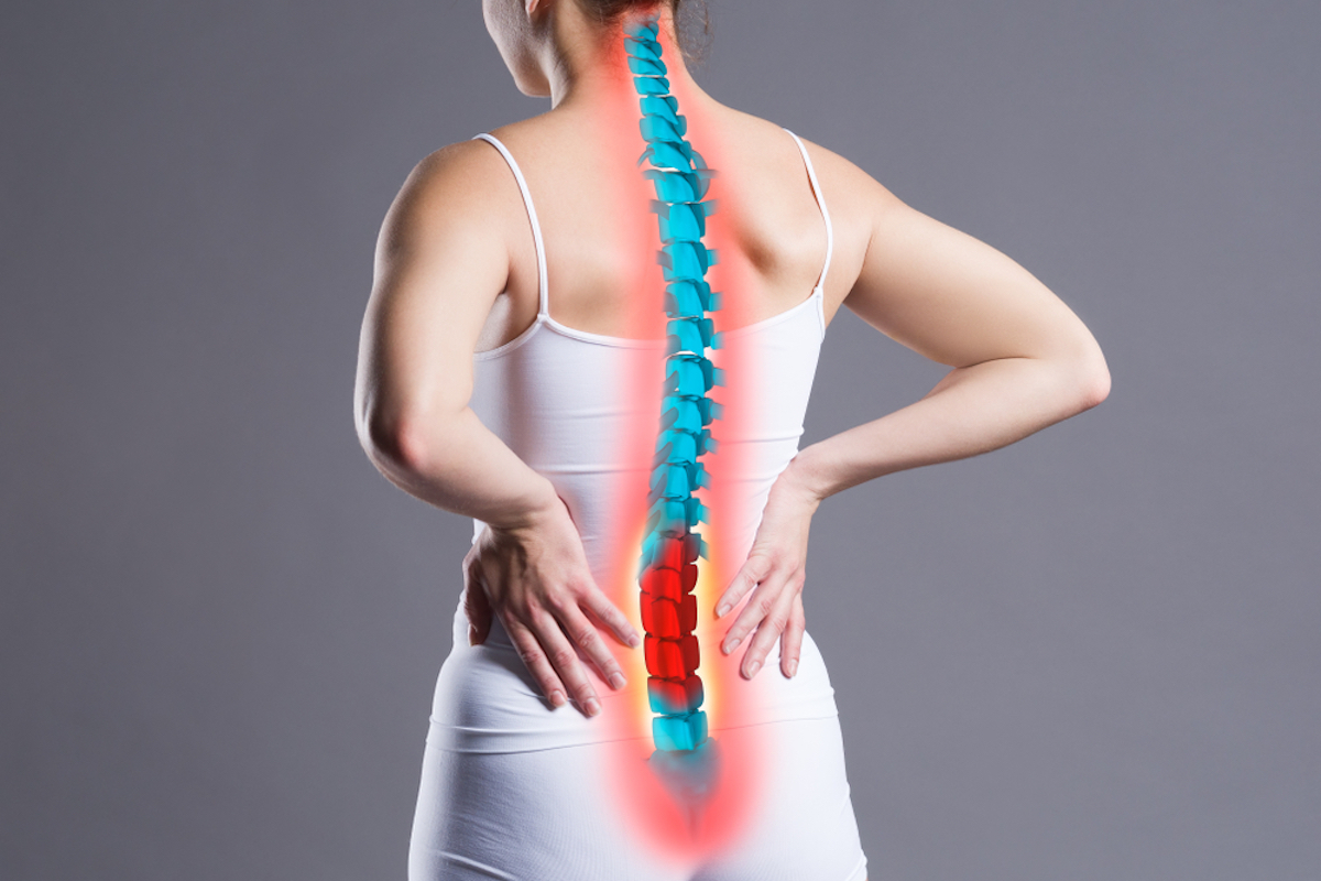 Spinal pain, woman with back pain on gray background, back injury, photo with marked skeleton