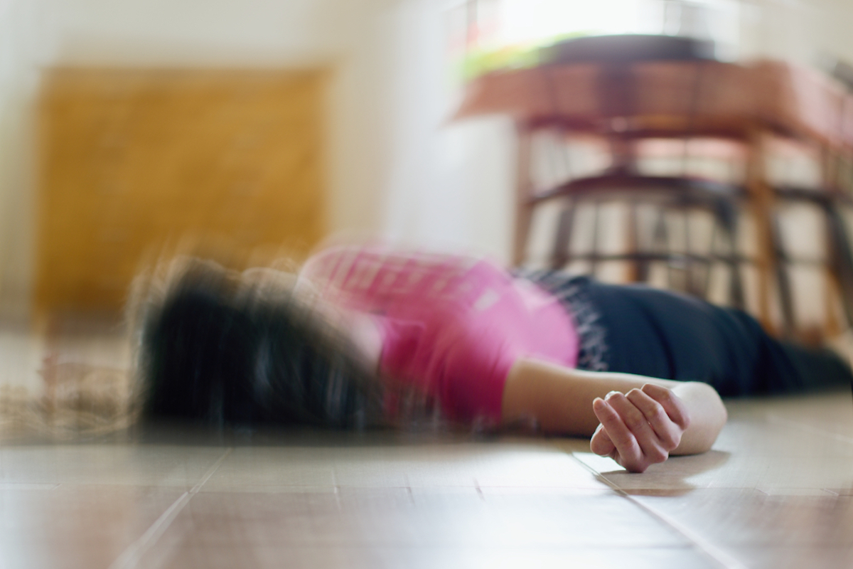 Woman lying on the floor at home, epilepsy, unconsciousness, fainting, stroke, accident or other health problem, health care, and medical concept
