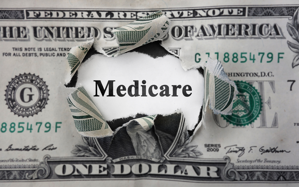 Medicare News Headline Inside of Torn Dollar Bill