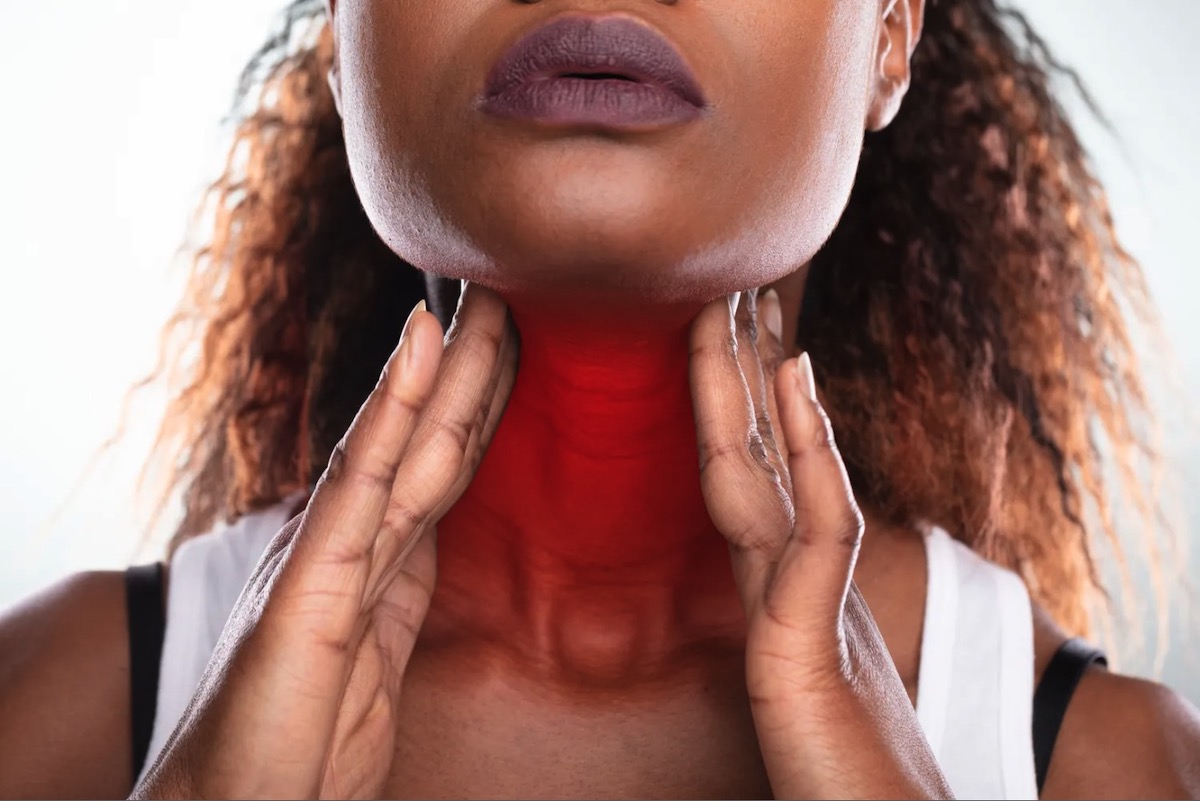 Close up of a Woman's Hand Touching Her Sore Throat. Strep Throat